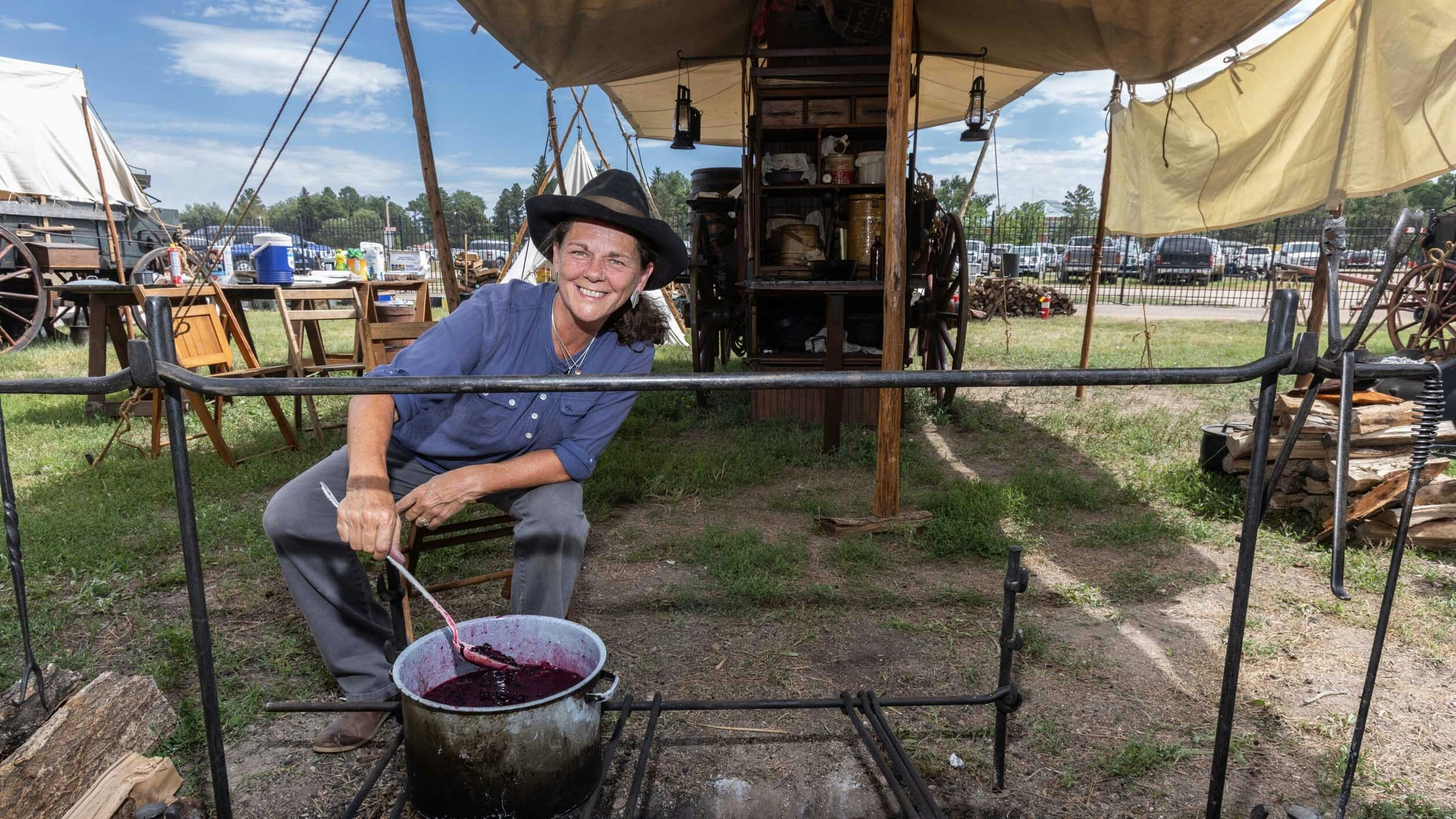 Susan Patrick from Watertown, SD cooks blueberries for her Blueberry Cobbler at the DT Wagon during the VIP Chuckwagon Dinner at Cheyenne Frontier Days on July 26, 2023.