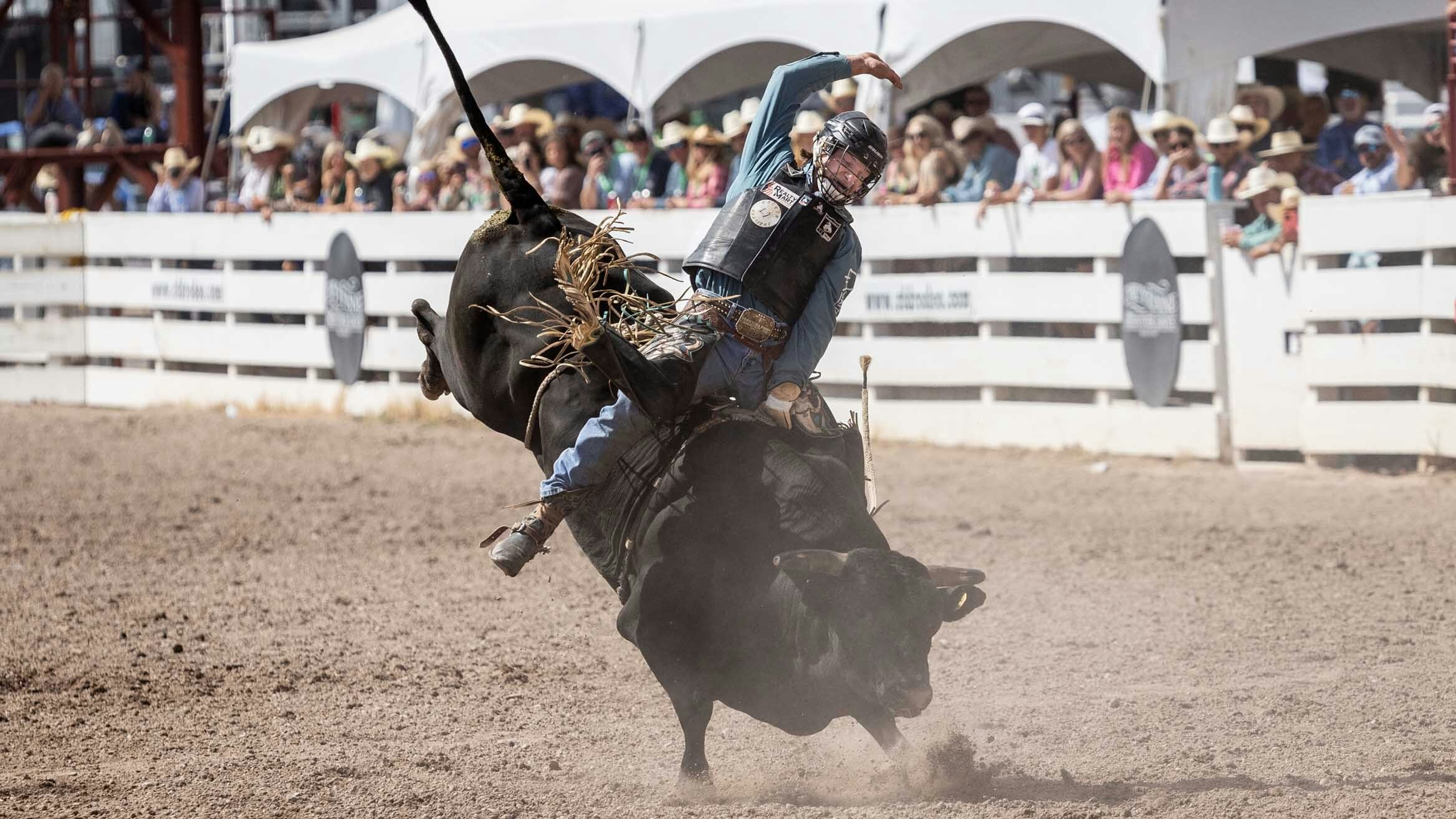 Fulton Rutland from Westville, OK rides his bull for a score of 87 points in the bull riding at Cheyenne Frontier Days on July 25, 2023.
