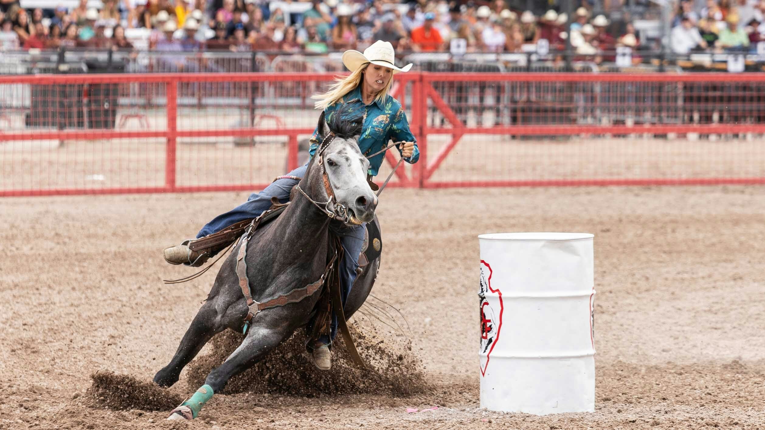 Karson Bradley from Big Piney, Wyoming goes around the 3rd barrel in the barrel racing at Cheyenne Frontier Days on July 23, 2023.