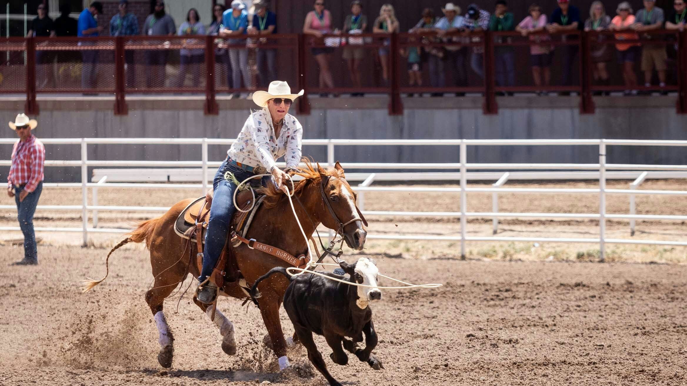 Linsay Rosser Sumpter from Fowler, Colorado ropes her calf in the Breakaway at Cheyenne Frontier Days on July 24, 2023.