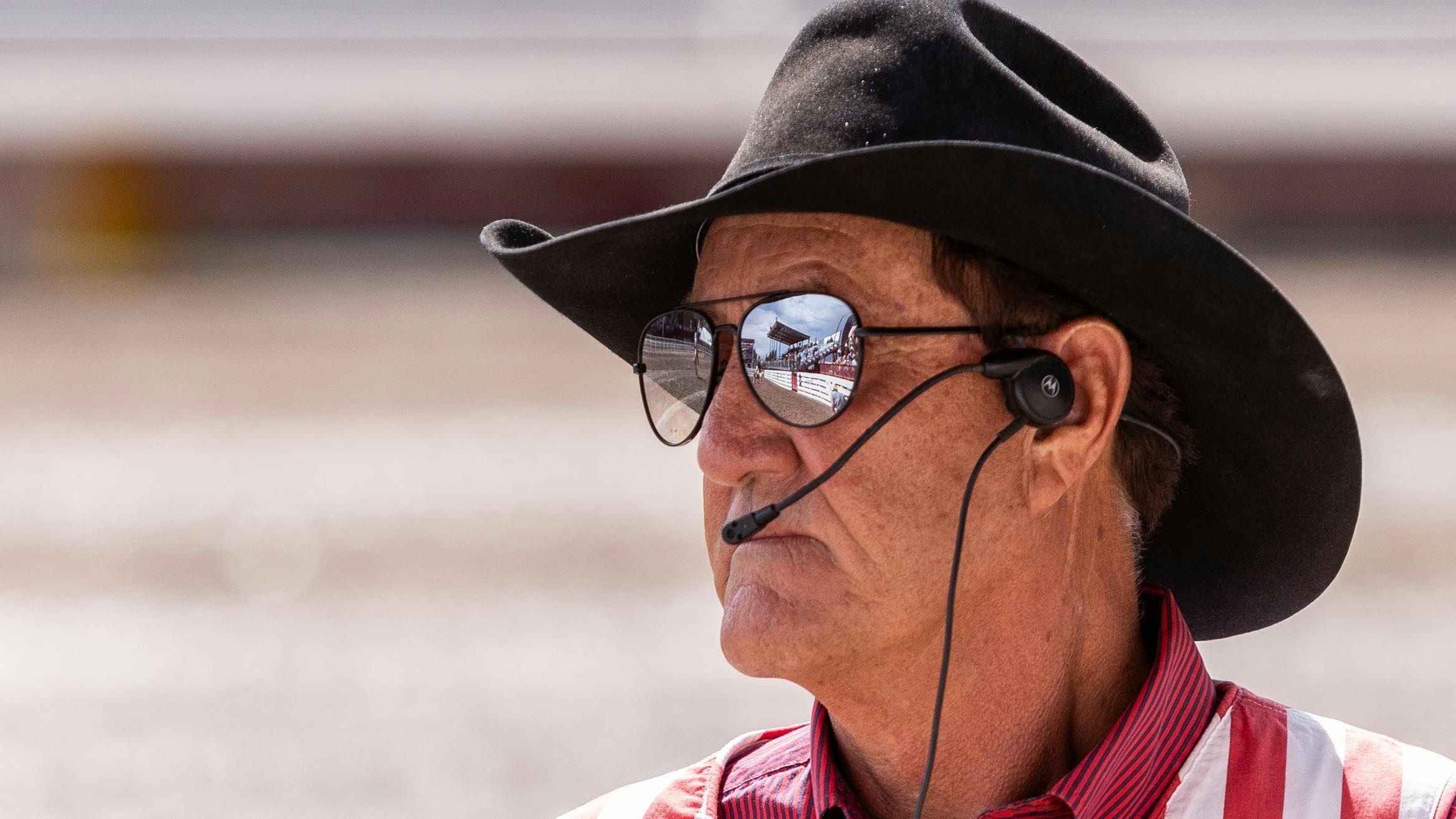 Arena and grand stands reflect in Cowboy’s sunglasses at Cheyenne Frontier Days on July 26, 2023.