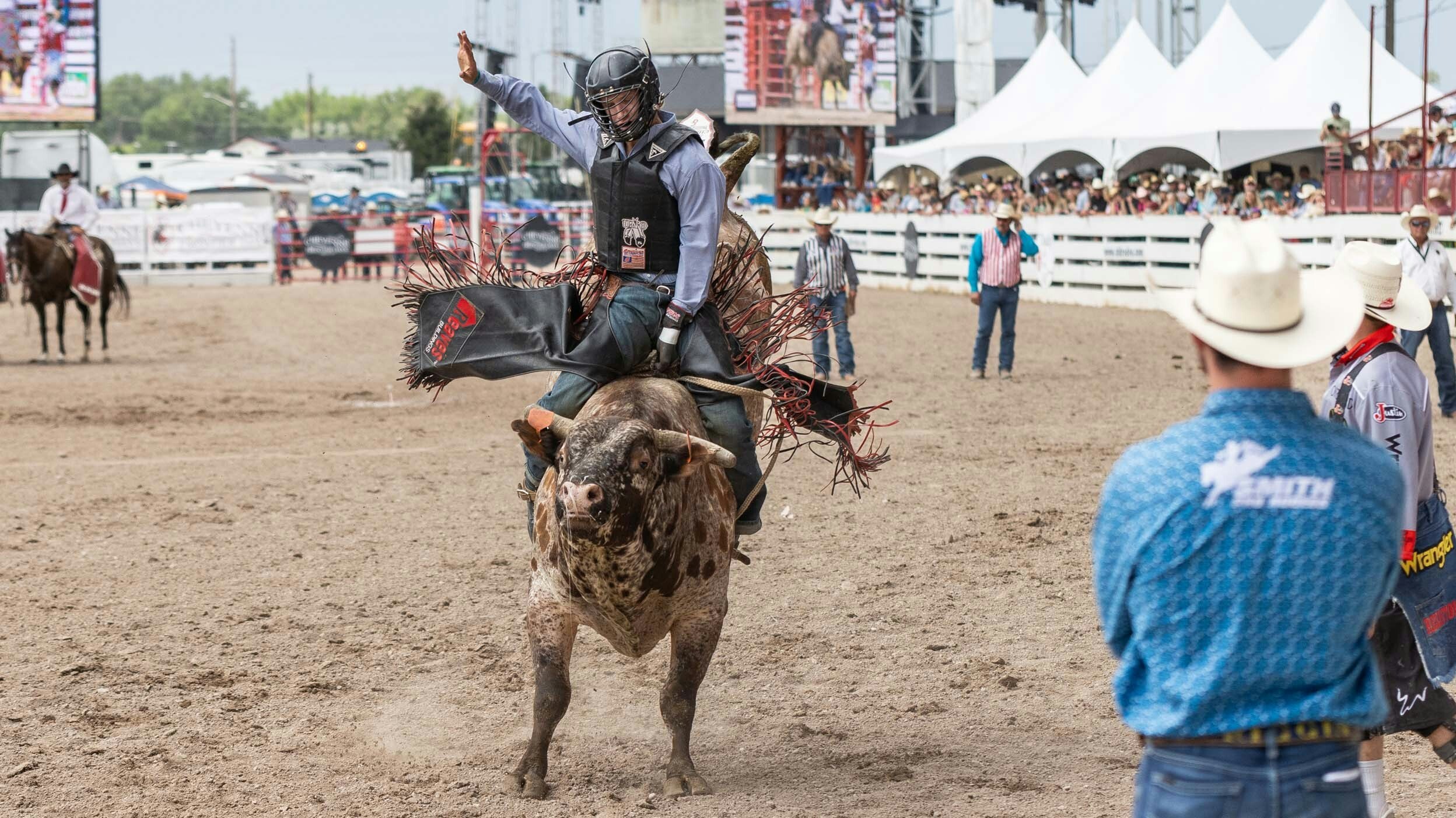 Riggin Shippy from Colome, SD rides his bull in the bull riding at Cheyenne Frontier Days on July 29, 2023.