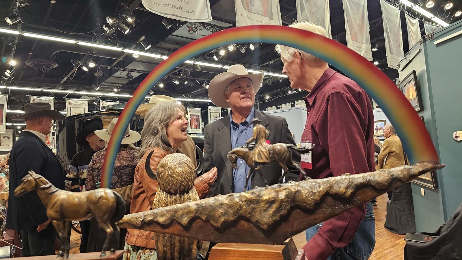 Artist Chris Navarro, center, at the Cheyenne Frontier Days Western Art Show. In the foreground, his sculpture, Chasing Rainbows, one of four pieces he brought to this premier Western art show. Navarro said it's one of his favorite shows, one he doesn't miss.