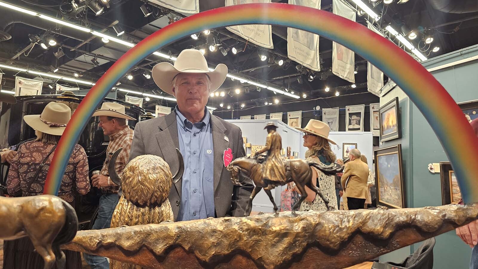 Artist Chris Navarro at the Cheyenne Frontier Days Western Art Show. In the foreground, his sculpture, Chasing Rainbows, one of four pieces he brought to this premier Western art show. Navarro said it's one of his favorite shows, one he doesn't miss.