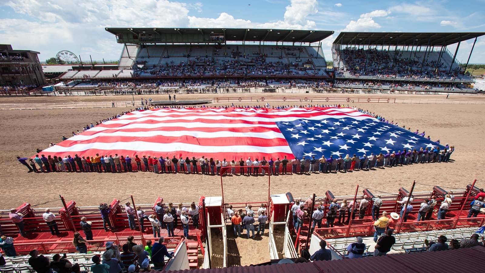 A large American flag is displayed by dozens of volunteers during the opening ceremonies of the Cheyenne Frontier Days Rodeo. As states gear up for America’s 250th birthday, Wyoming is planning a huge statewide Westen blowout. Old West icons, outlaws, historic trails, and a slate of uniquely Wyoming events will call to tourists seeking Western adventures.