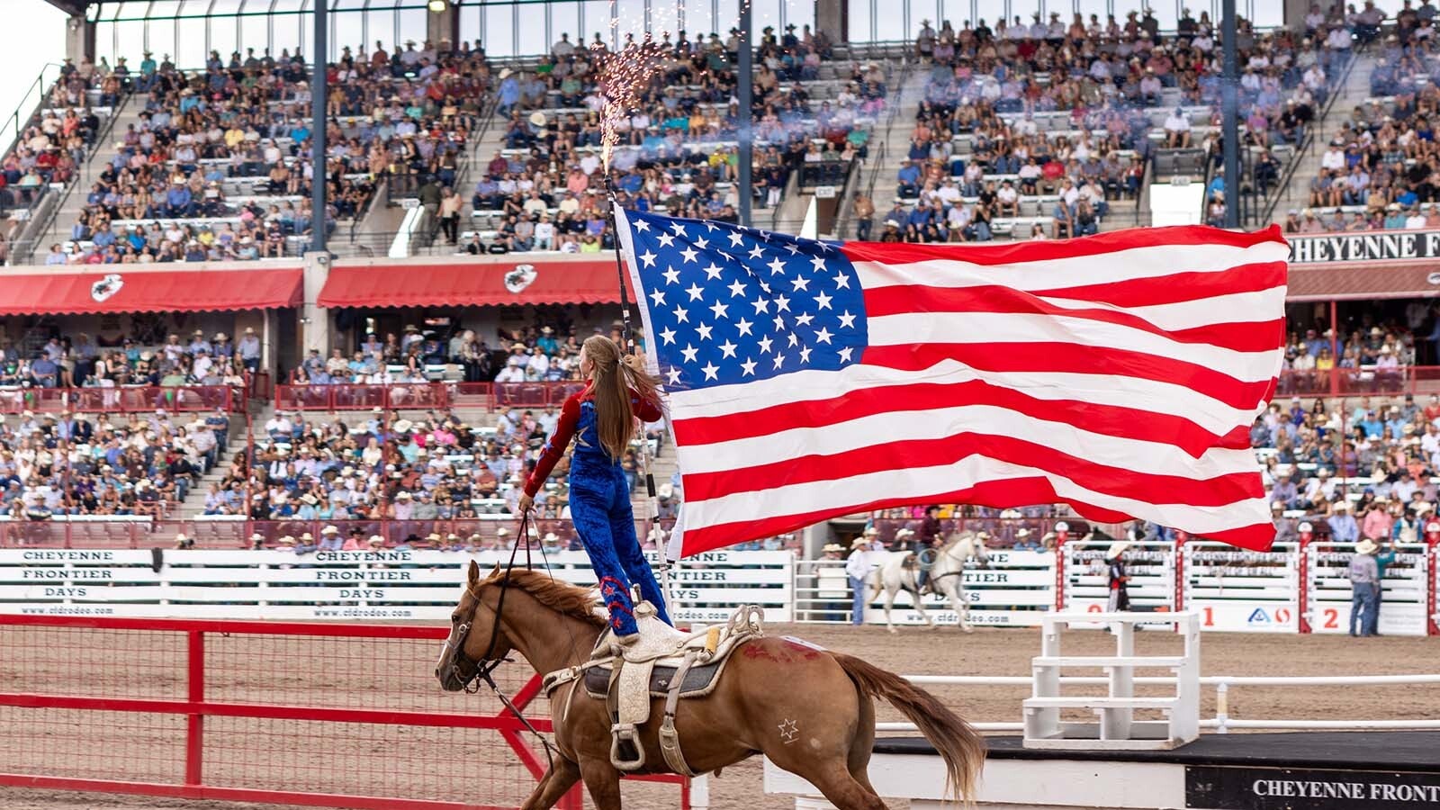 A rider with a large American flag does a lap around the Cheyenne Frontier Days arena. As states gear up for America’s 250th birthday, Wyoming is planning a huge statewide Westen blowout. Old West icons, outlaws, historic trails, and a slate of uniquely Wyoming events will call to tourists seeking Western adventures.
