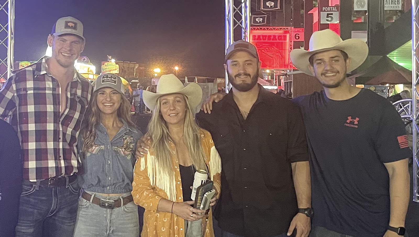 Trey Kothe, left, and Sheena Krehbiel with friends just before the Eric Church concert in 2021, where Trey finally won Sheena over.