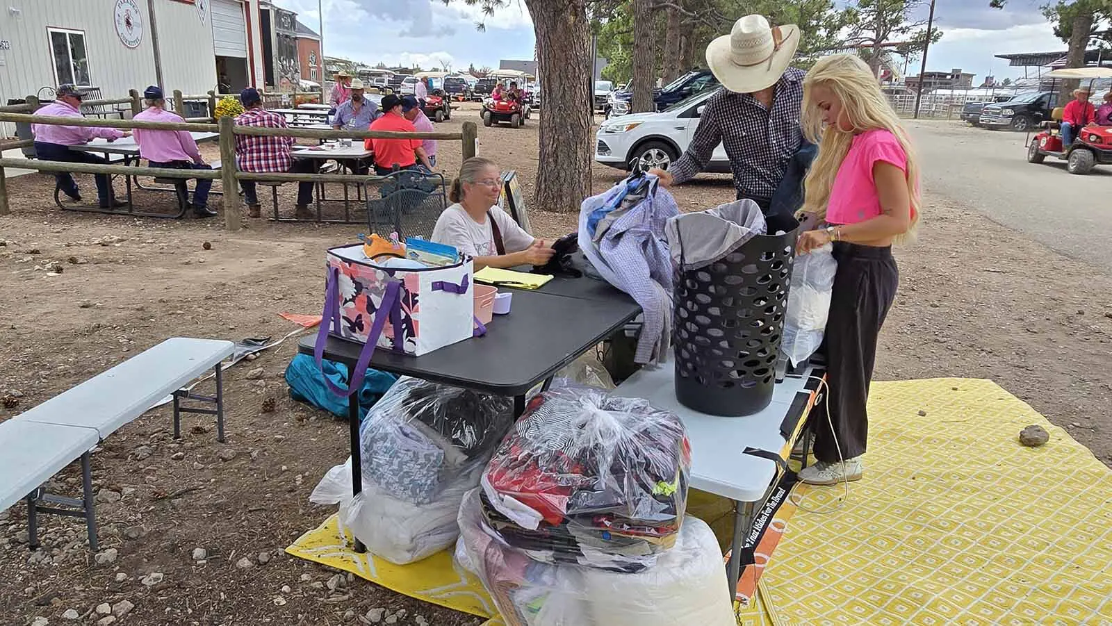 Hudson Bolton, center, with his girlfriend Kennedy, drops off a load of laundry with Drop N Dash during Cheyenne Frontier Days while Jessica Snider, left, looks on.