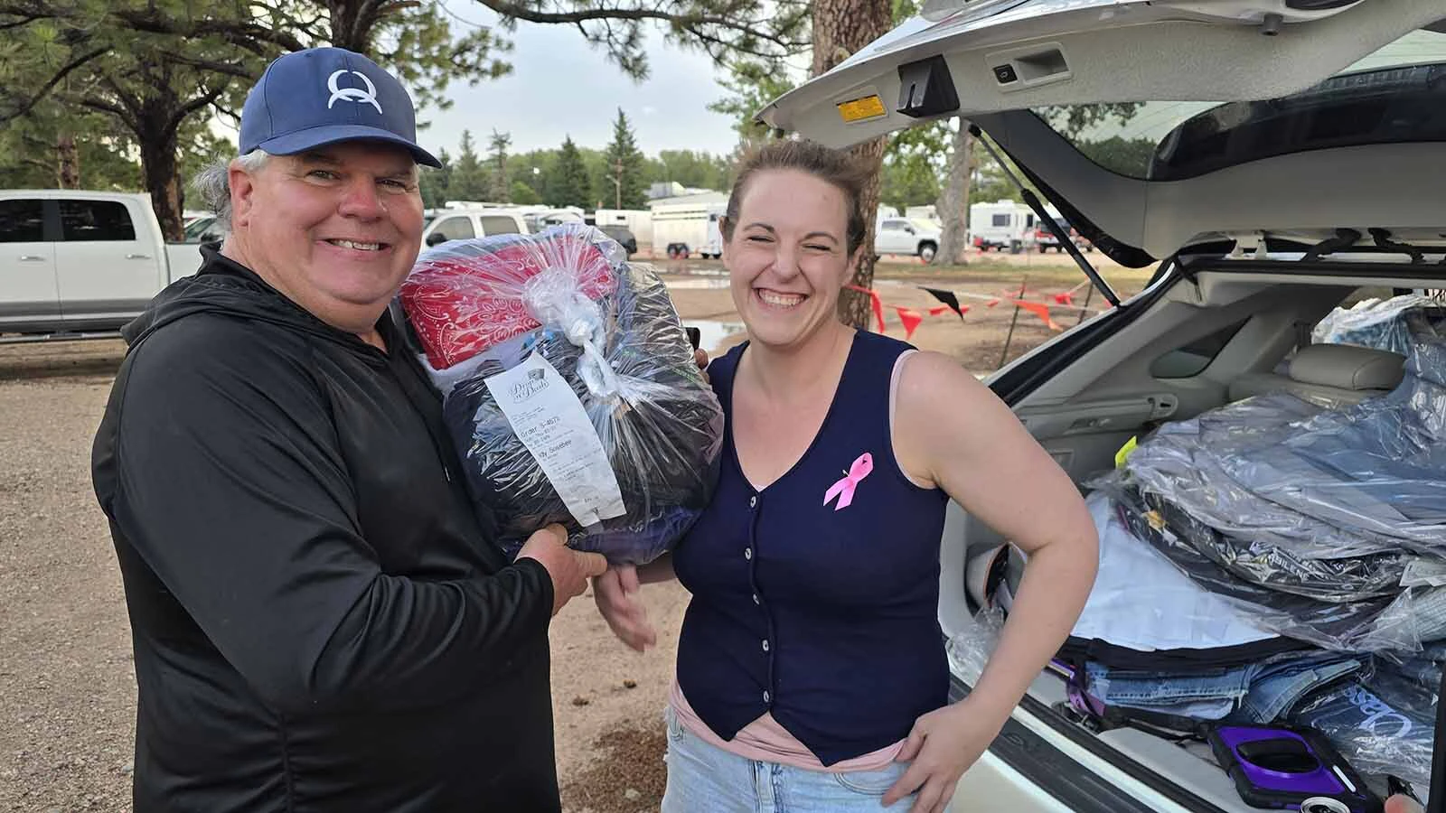 Rodeo clown Cody Sosebee picks up a batch of fresh rodeo outfits from Courtney Shillen's Drop N Dash service at Cheyenne Frontier Days. The laundry service has pulled half a month's worth of extra-dirty  laundry out of Frontier Park in less than a week.