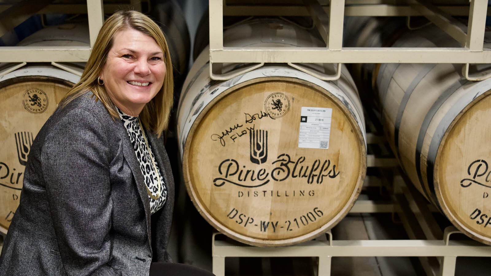 First lady Jennie Gordon signs a barrel at Pine Bluffs Distilling. A portion of sales of the Joe Pickett Bourbon will benefit the Wyoming Hunger Initiative led by Gordon.