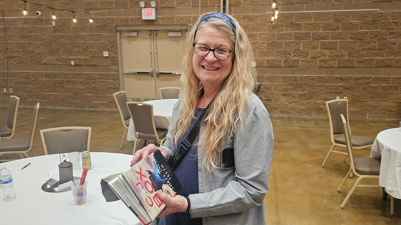 Koby Shell with a signed copy of a C.J. Box book she is taking home to give a friend who is a big fan of Box's book.