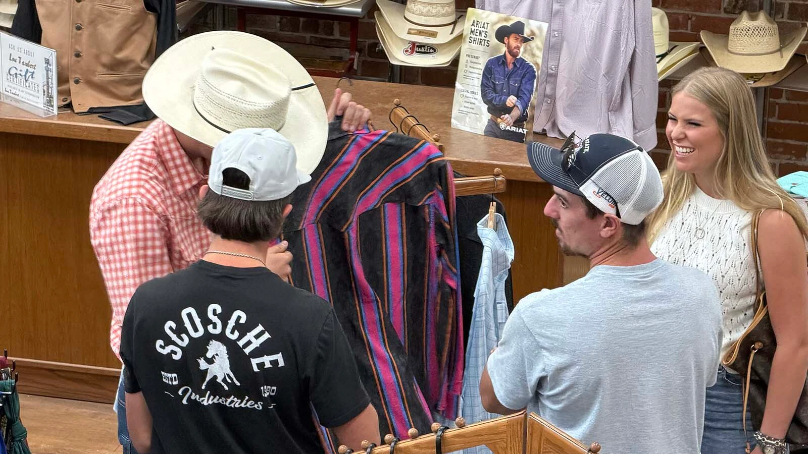 Customers browse for Western wear at Lou Taubert Ranch Outfitters during the College National Finals Rodeo.
