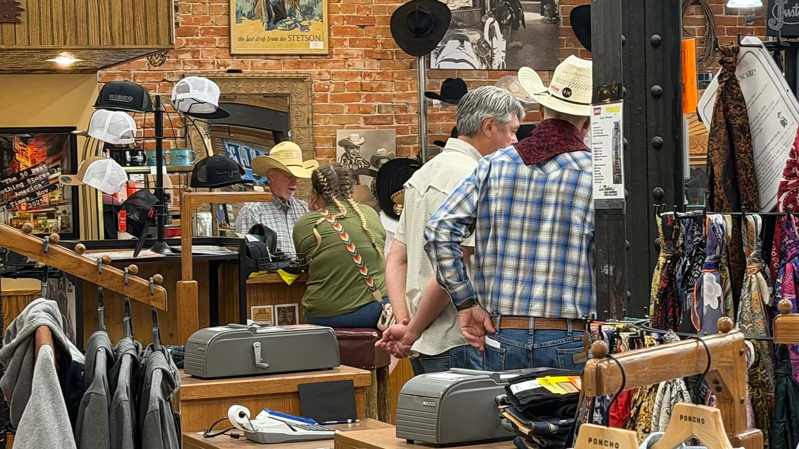 Customers browse for Western wear at Lou Taubert Ranch Outfitters during the College National Finals Rodeo.