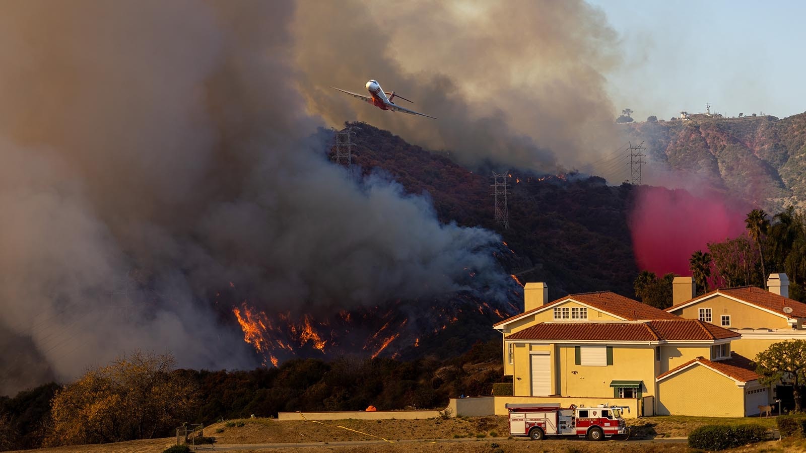 Fire air operations drop fire retardant on flames from the Palisades Fire along Mandeville Canyon in the Brentwood community of Los Angeles, Calif.