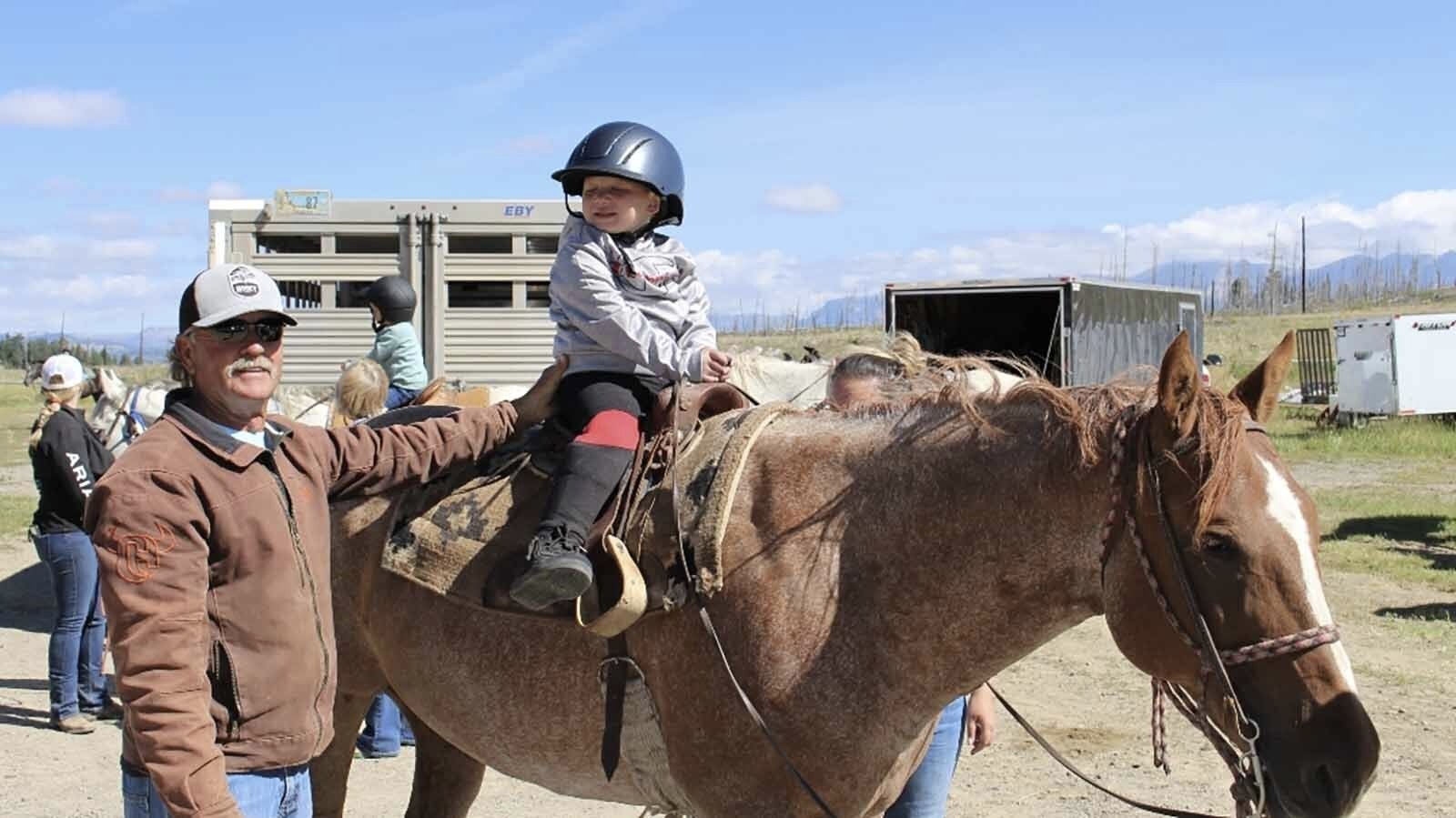 After he lost his son Jason to cancer, Rocky Eades’ friends formed a foundation to help other families financially in Wyoming when faced with childhood cancer and tumors. Eades is pictured here with Mikey Smith on a horse.