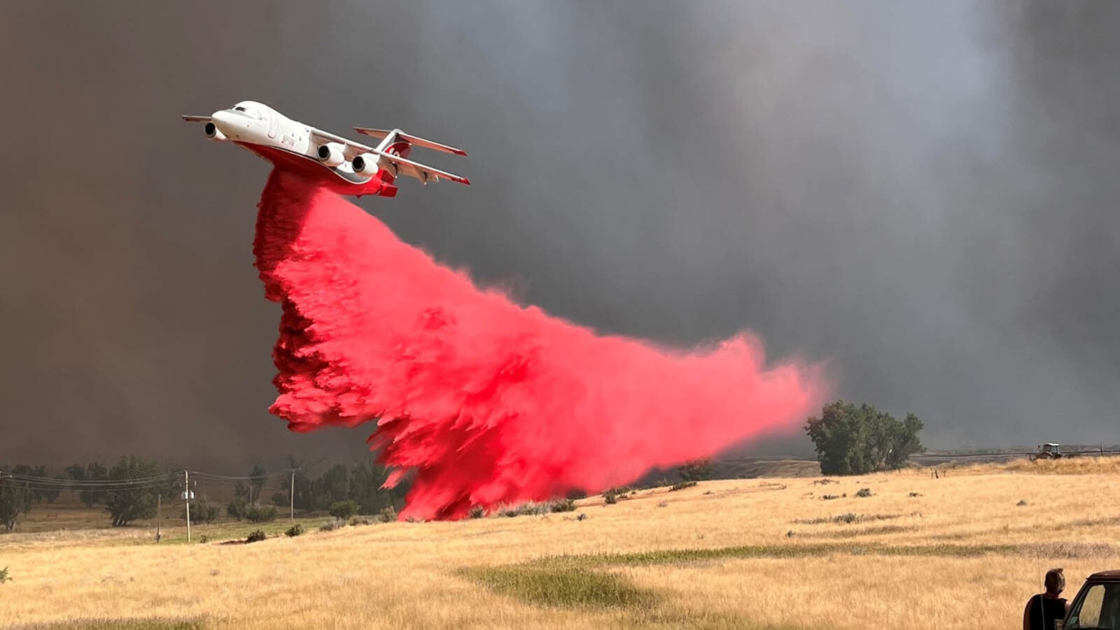 A plane drops fire retardant slurry on one of the large Campbell County, Wyoming, wildfires.