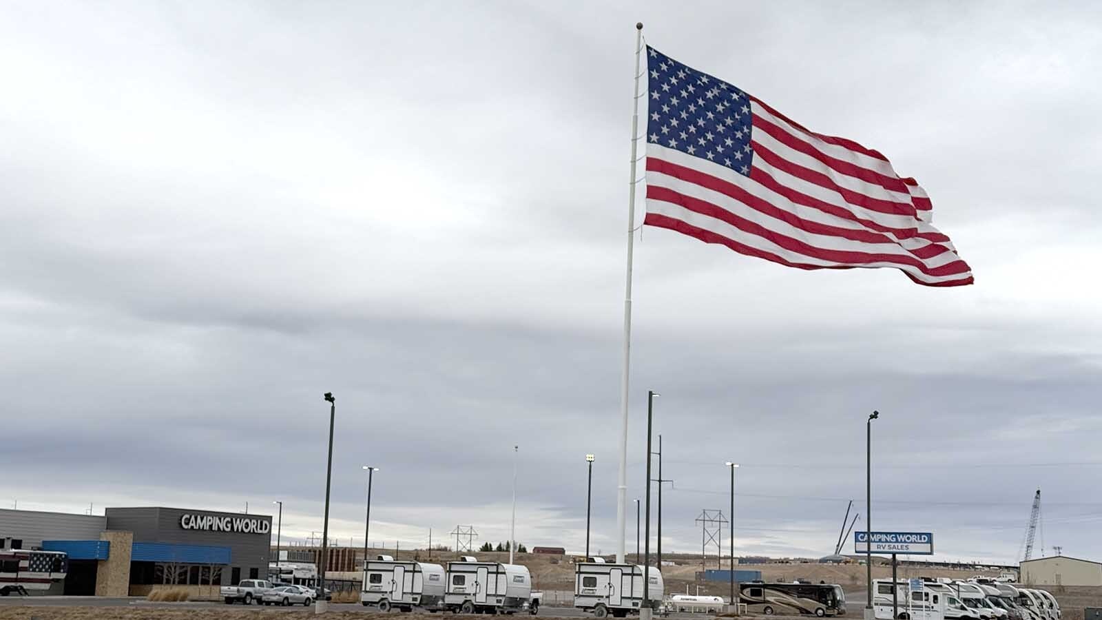 Wyoming’s fierce winds tattered Camping World’s massive 40-by-80-foot flag in Cheyenne, engineered for 100 mph gusts but no match for this winter’s fury. At $130,000 each, the hand-sewn symbols of veteran gratitude require frequent, costly replacements.