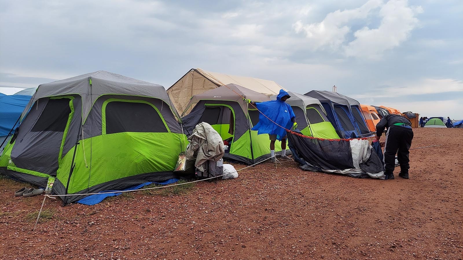 Campers dry out and reassemble their tent following Tuesday's storm.