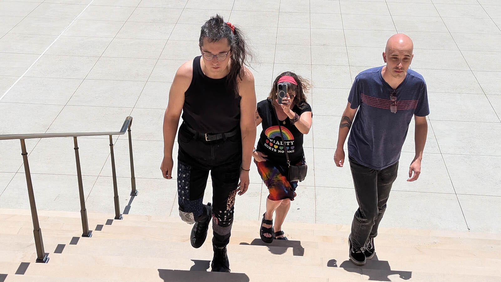 Transgender woman Rihanna Kelver, left, and two supporters walk up the front steps of the Wyoming Capitol on Tuesday, July 1, 2025, with the intention of using the women’s restroom next to Gov. Mark Gordon’s office and violating a state law restricting public building restroom users to the restroom of their birth sex.
