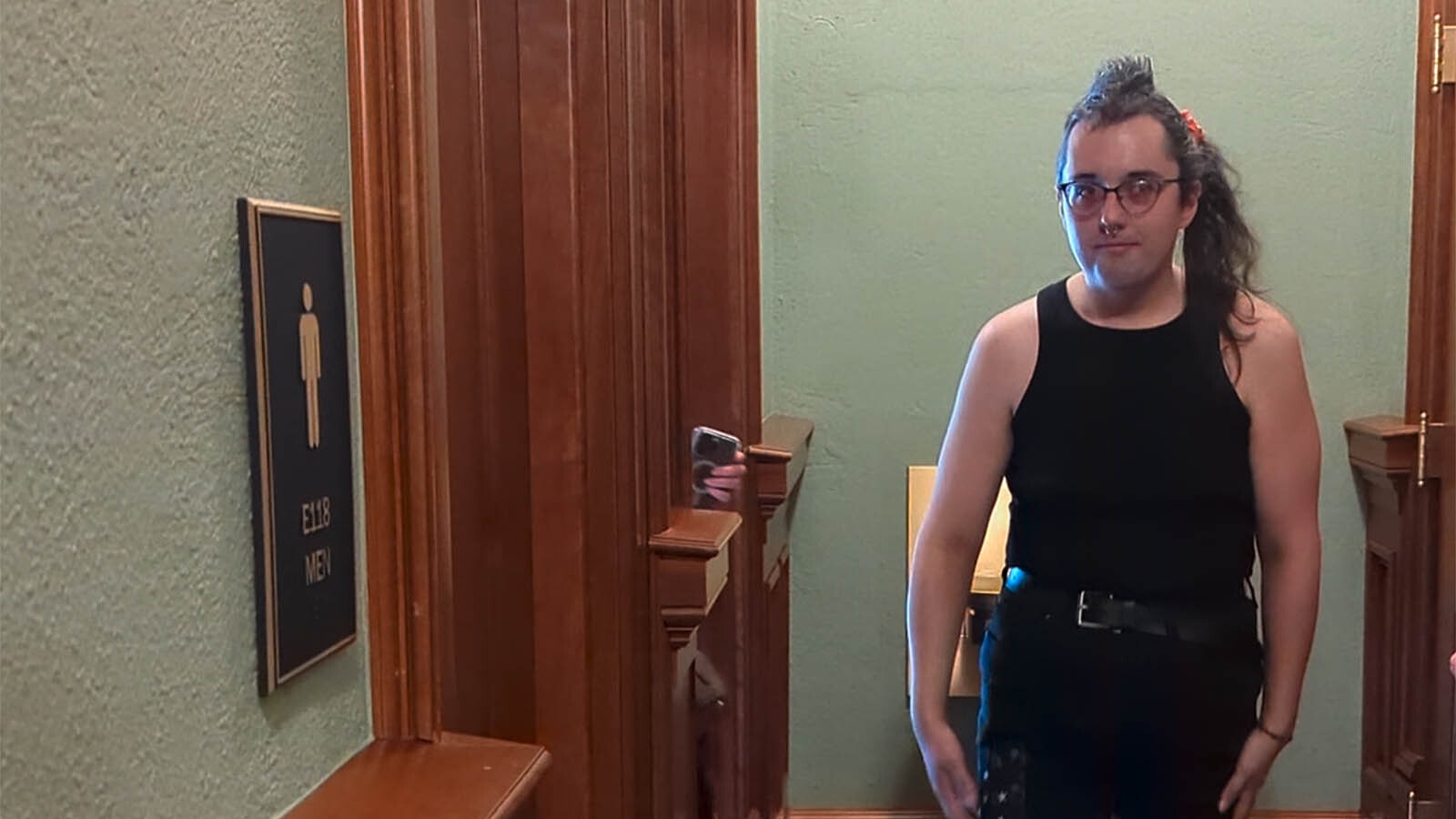 Rihanna Kelver comes out of the women's bathroom near Gov. Mark Gordon's office in the Wyoming Capitol on Tuesday. Kelver used the bathroom to protest Wyoming's new bathroom ban law that went into effect Tuesday, July 1, 2025.