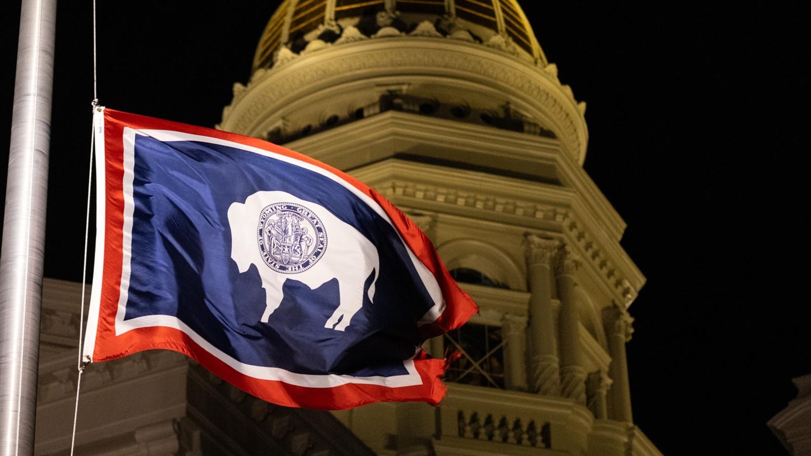 Capitol dome and night with state flag close 1 17 25