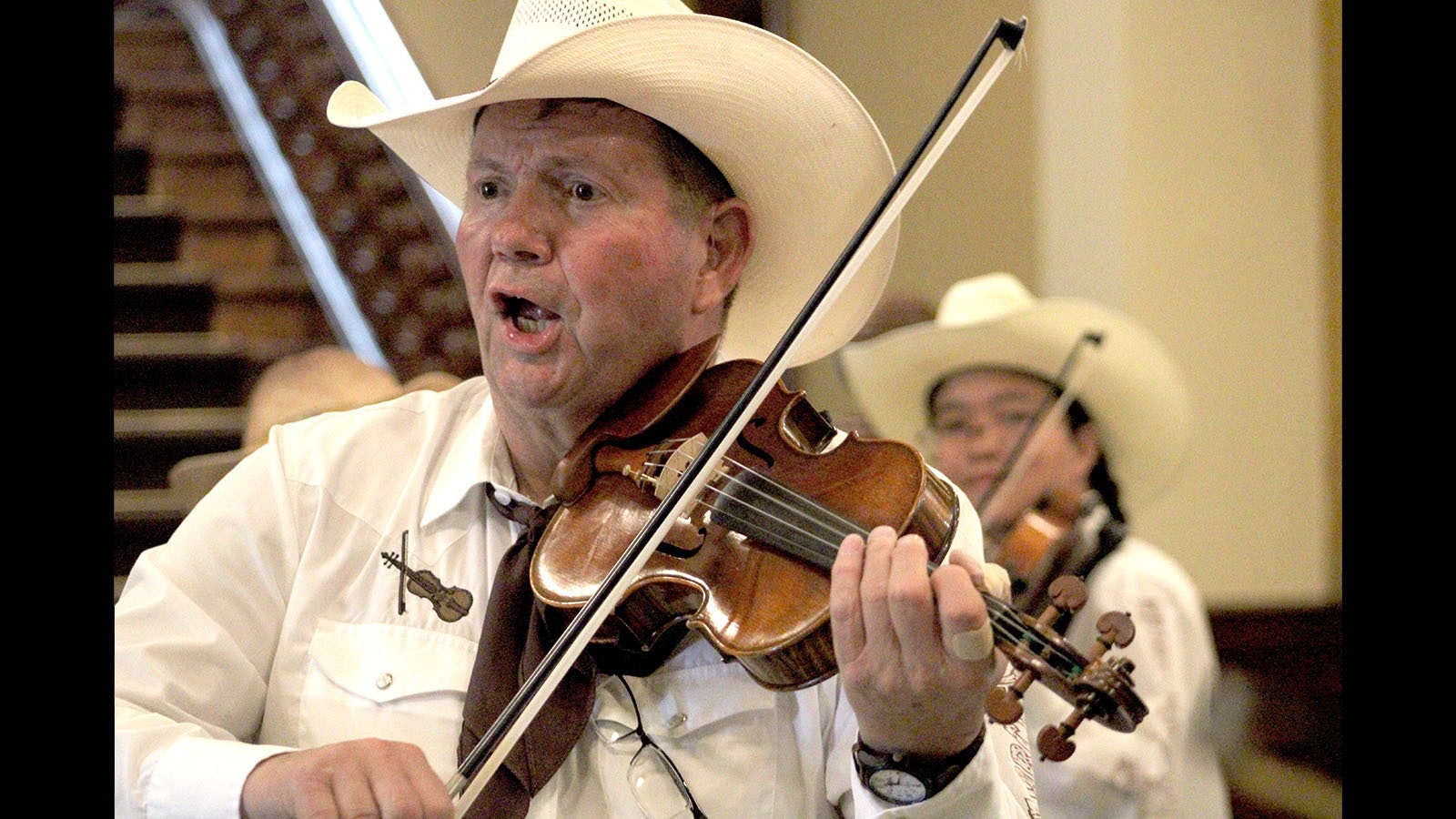 Bob Matthews leads the Cheyenne Fiddle Orchestra in a perforce at the state Capitol on Saturday.