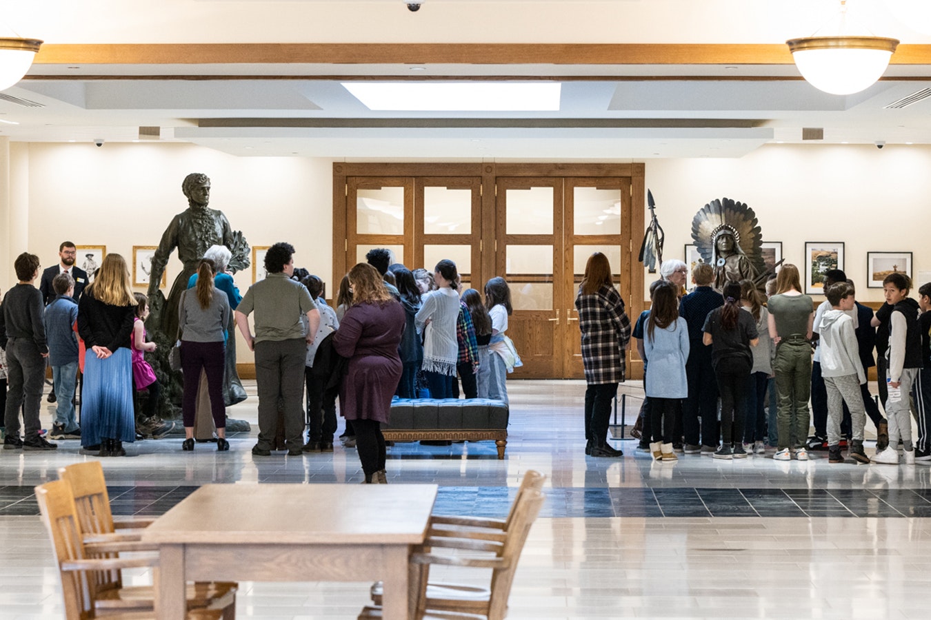 Visitors view the large bronze sculptures of Esther Howard Morris, left, and Chief Washakie in the Capitol Extension hallway in the basement of the state Capitol building in Cheyenne during the 2023 legislative session.