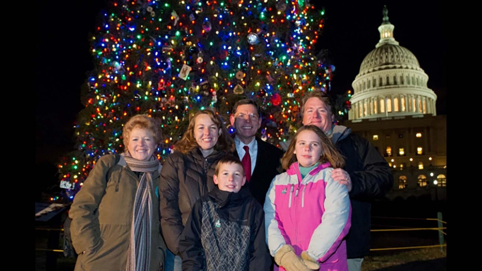 Sen. John Barrasso with Daniel Sitter and his family from Lincoln County, Wyoming, in front of the Wyoming Capitol tree in 2010.