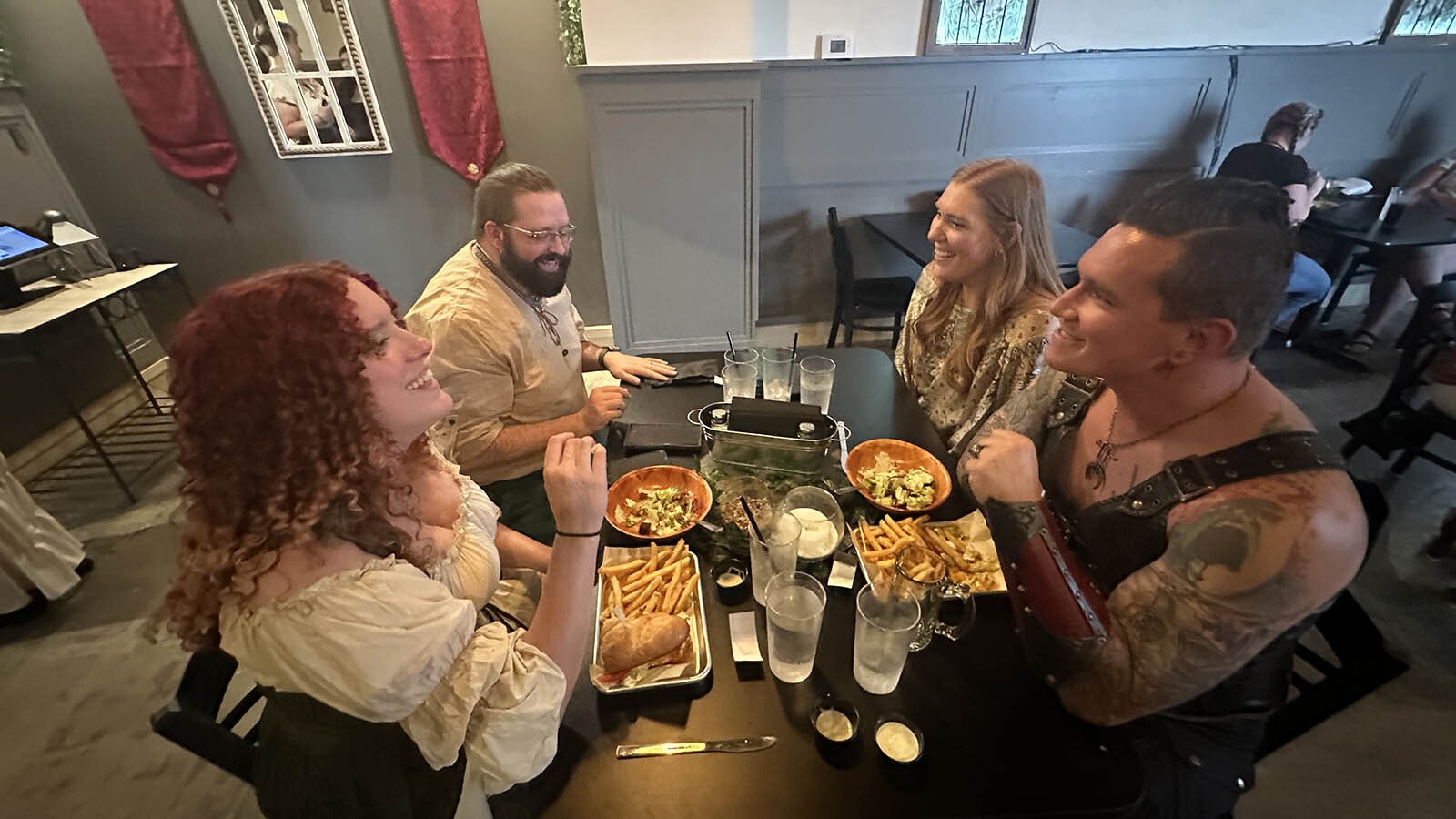 From right, Paul “The Barbarian” Miller, Raven Jackson, Tory Jackson and Tenika Miller enjoy a medieval meal at Captain Scurvy's Black Dragon Den.