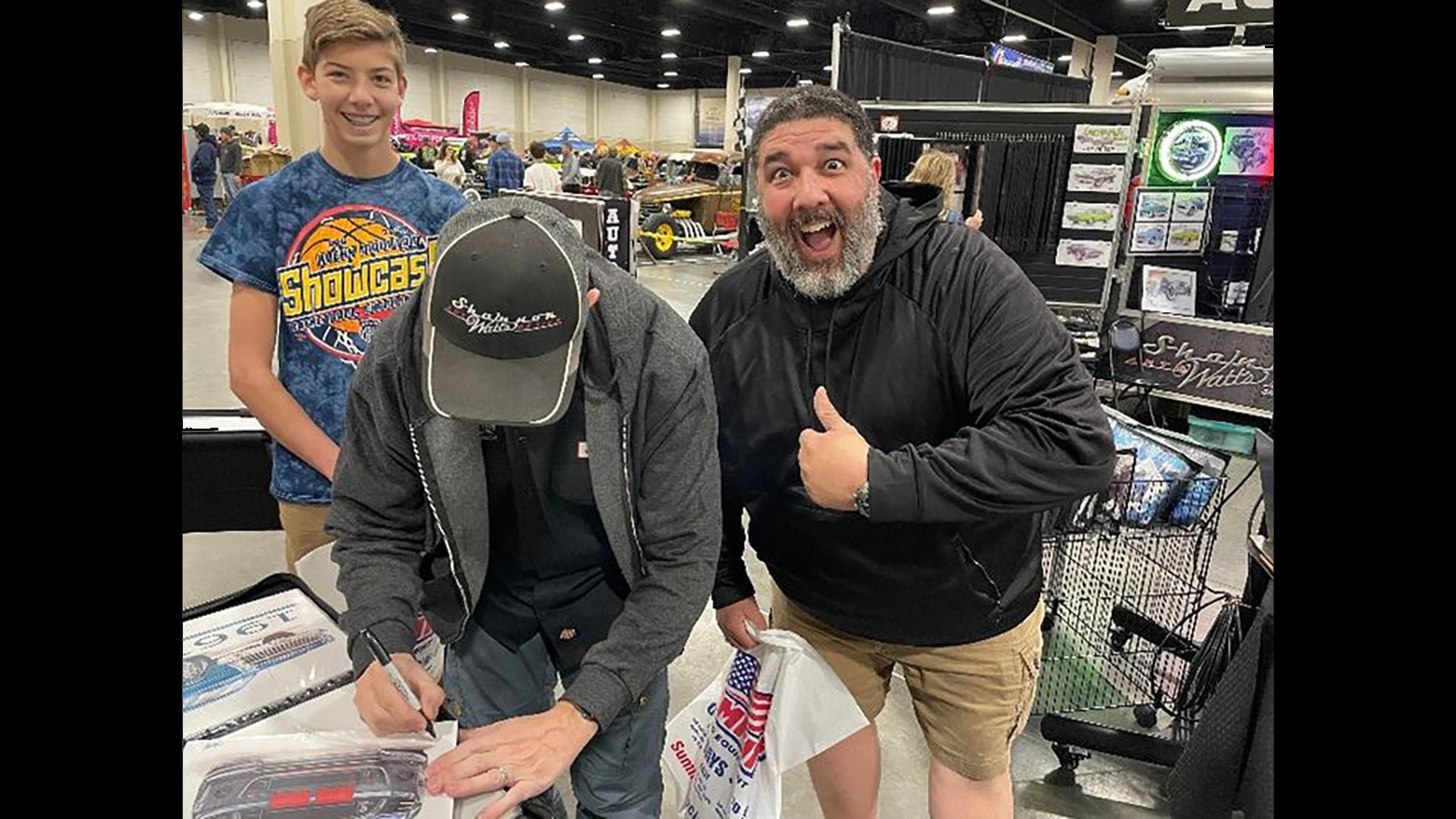 A fan is excited to get Shannon Watts’ autograph at a car show.