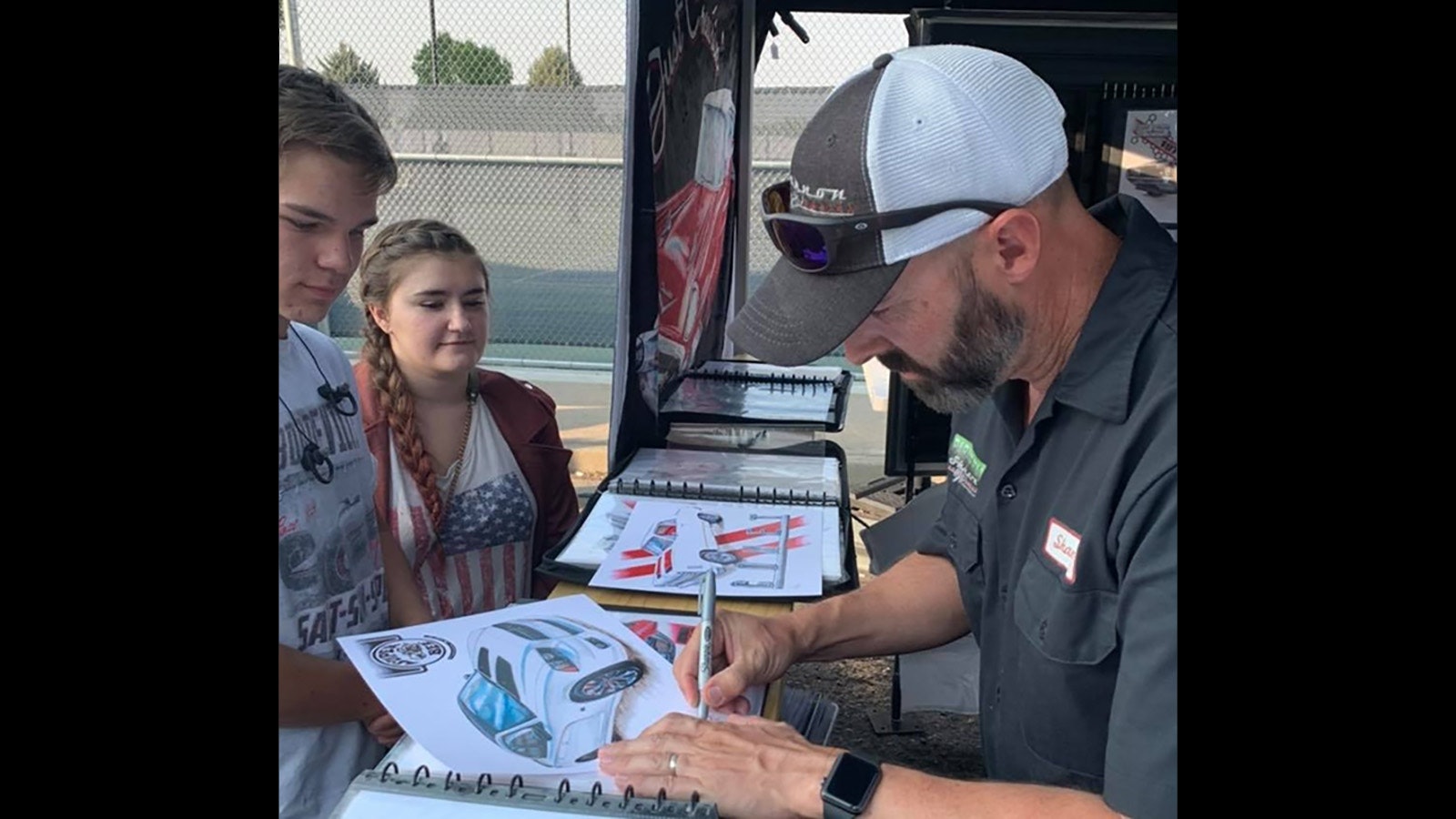 Shannon Watts has transformed his artwork into prints, clocks, apparel and stickers and is in demand across the country. Here he signs a print for fans in Elko, Nevada.