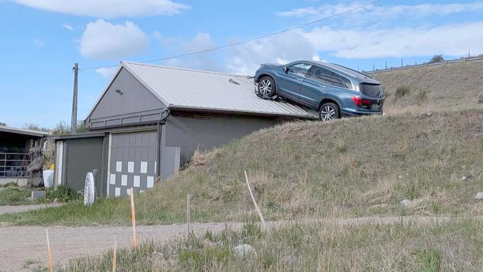 The Montana Department of Transportation had to rescue a driver from an SUV that crashed through a guardrail, toppled down an embankment and landed on the roof of a garage this week. Most people, however, say the real hero is the garage roof.