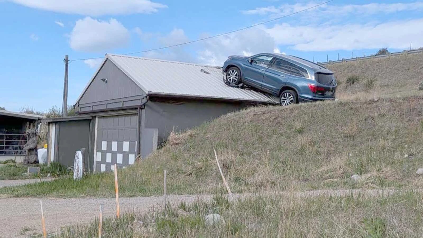The Montana Department of Transportation had to rescue a driver from an SUV that crashed through a guardrail, toppled down an embankment and landed on the roof of a garage this week. Most people, however, say the real hero is the garage roof.