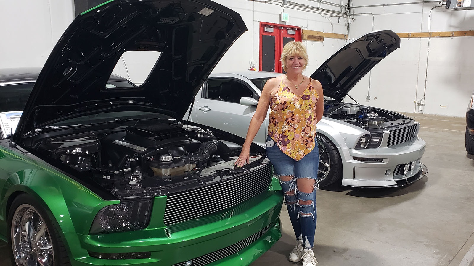 Brenda Treuthardt poses with the 2007 green Mustang she calls Sins of Envy.