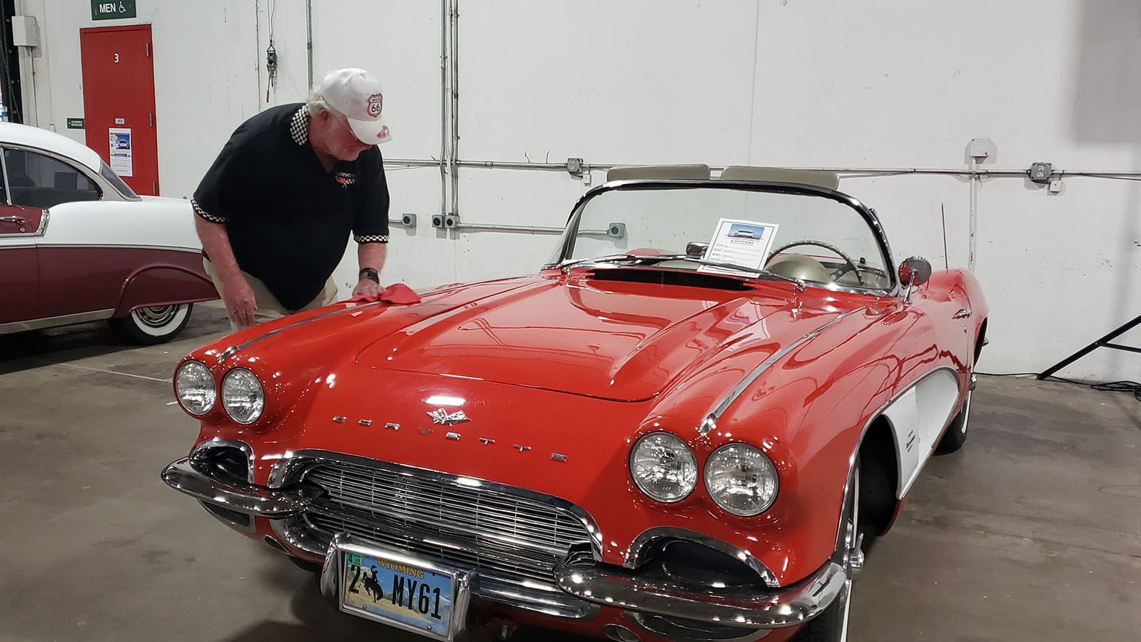 Randy Danclif polishes his 1961 Corvette after a brief downpour during the Cars, Cigars and Guitars charity fundraiser in Cheyenne.