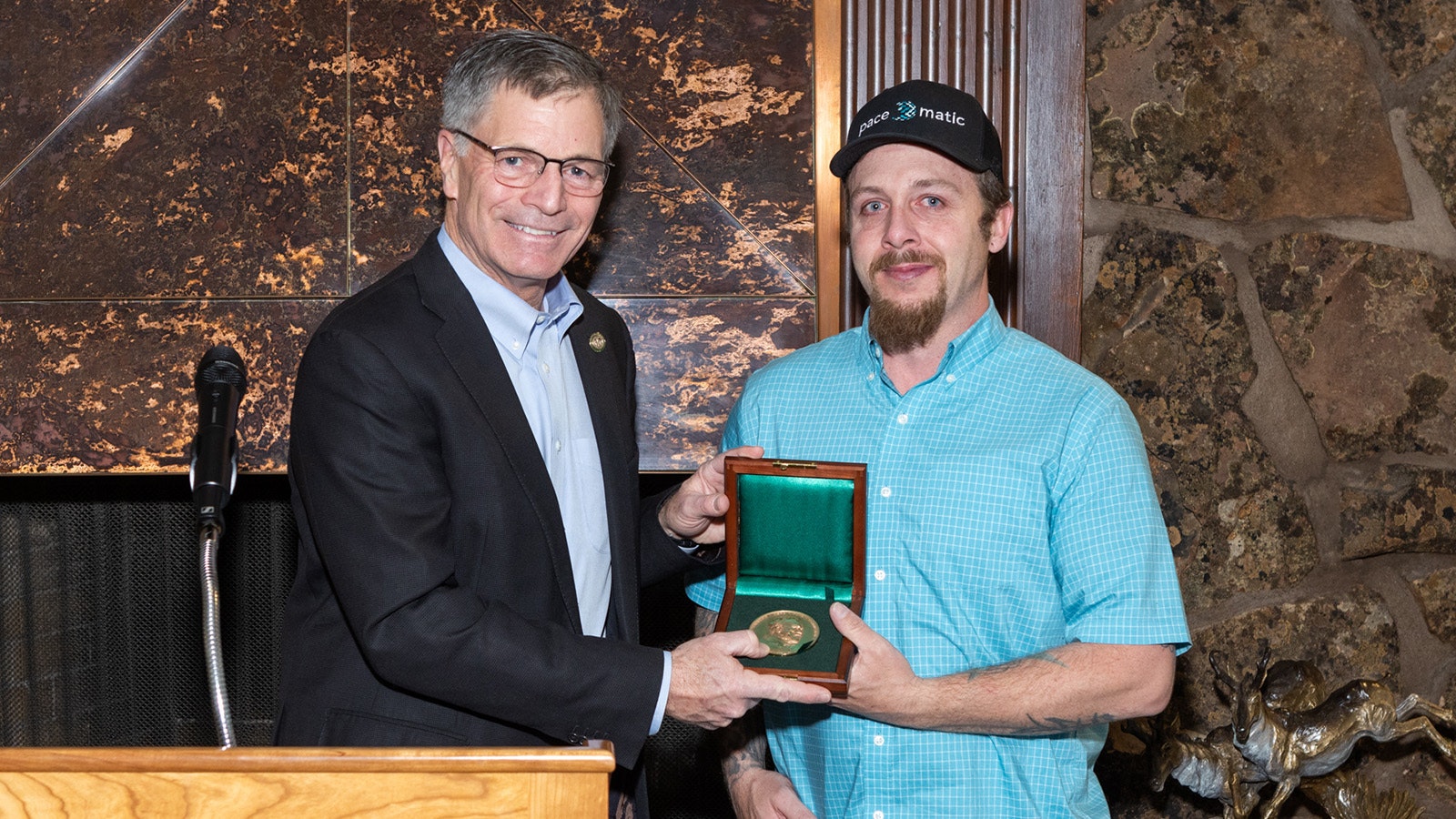 Ryan Pasborg, right, receives the Carnegie Medal from Gov. Mark Gordon on April 27, 2024, at the Governor's Mansion in Cheyenne. The medal is the nation's highest civilian honor for heroism. He saved a mother and her young son from a burning trailer on his way to work the morning of Feb. 1, 2022.