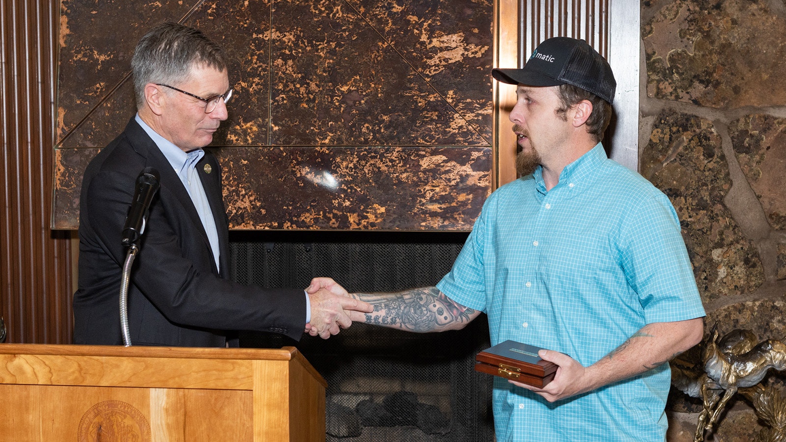 Ryan Pasborg, right, receives the Carnegie Medal from Gov. Mark Gordon on April 27, 2024, at the Governor's Mansion in Cheyenne. The medal is the nation's highest civilian honor for heroism. He saved a mother and her young son from a burning trailer on his way to work the morning of Feb. 1, 2022.