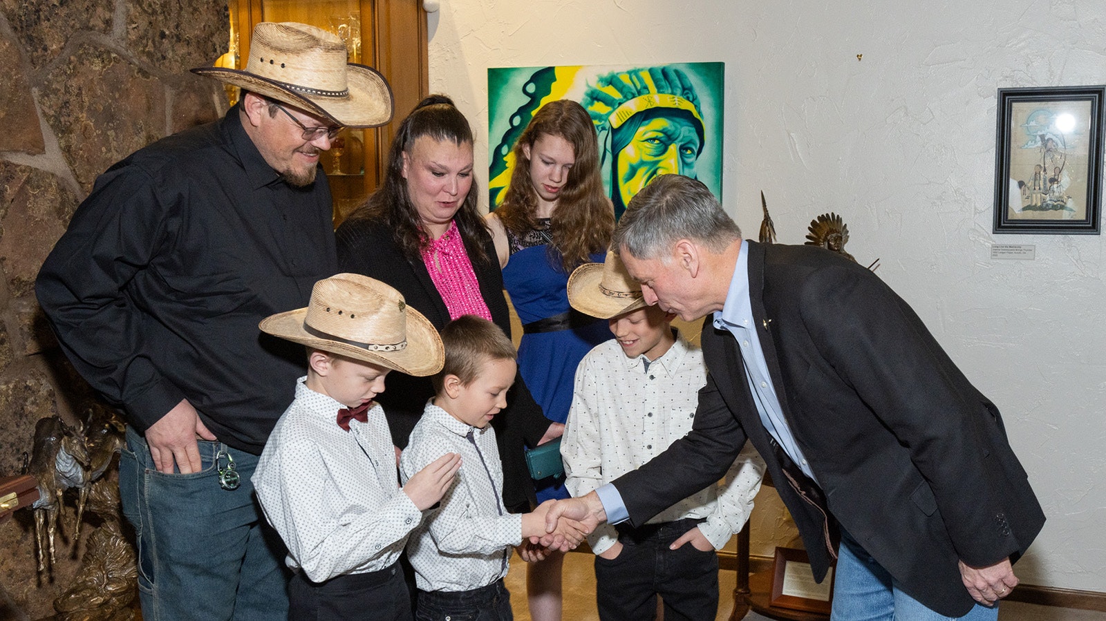 Gov. Mark Gordon, right, meets Stephanie Wadsworth and her son, Weston, and the rest of their family at the Governor's Mansion in Cheyenne on April 27, 2024. Stephanie and Weston were pulled out of a burning trailer the morning of Feb. 1, 2022, by local resident Ryan Pasborg. The family and Pasborg were in Cheyenne to receive his Carnegie Medal.