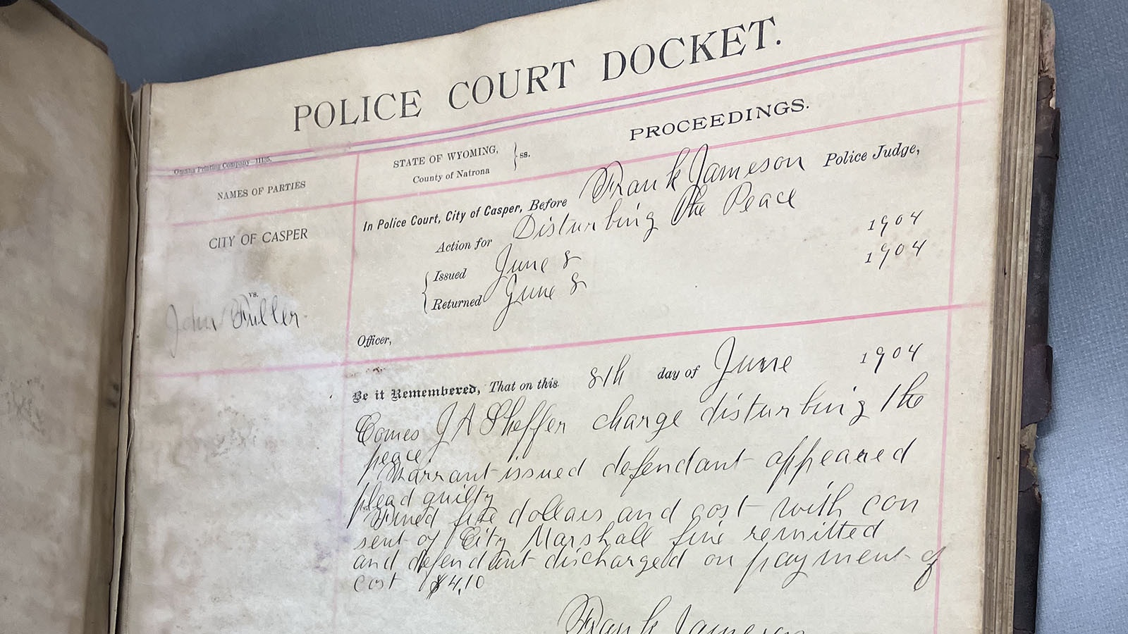 The first page in the Casper Police Court Docket book shows a John Fuller charged with disturbing the peace on June 8, 1904.