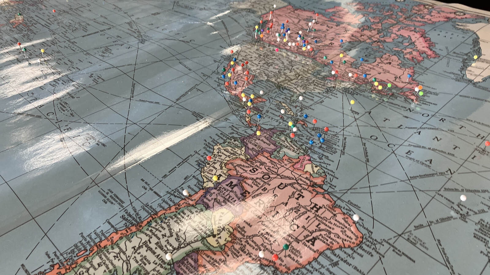 A map in the customs office has pins showing where flights have originated from over the years.