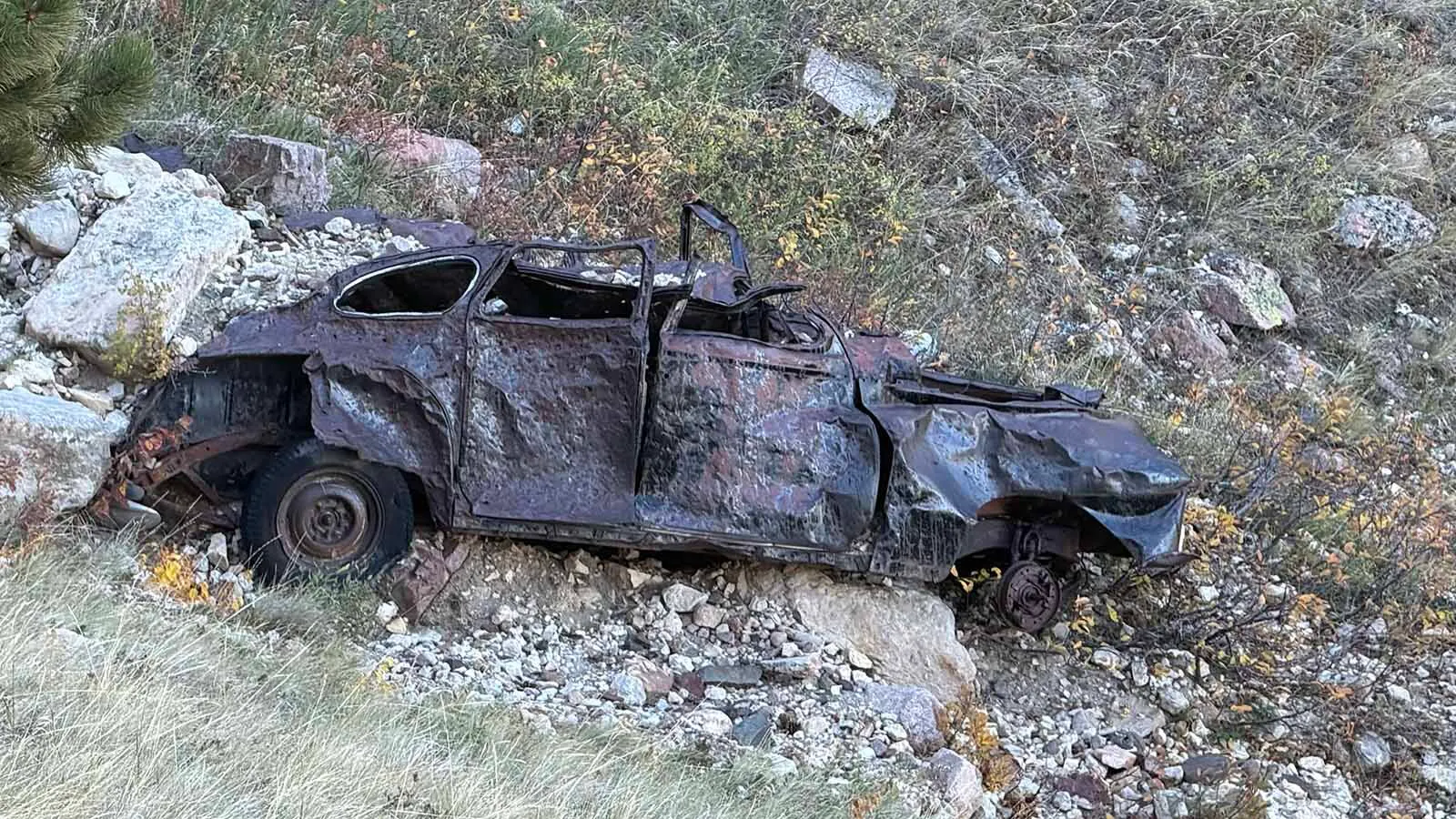 The battered remains of an old car sit below the Bridle Trail on Casper Mountain, where the wreck has been a familiar landmark to generations of hikers and horseback riders. Exactly when and how it got there remains a mystery.