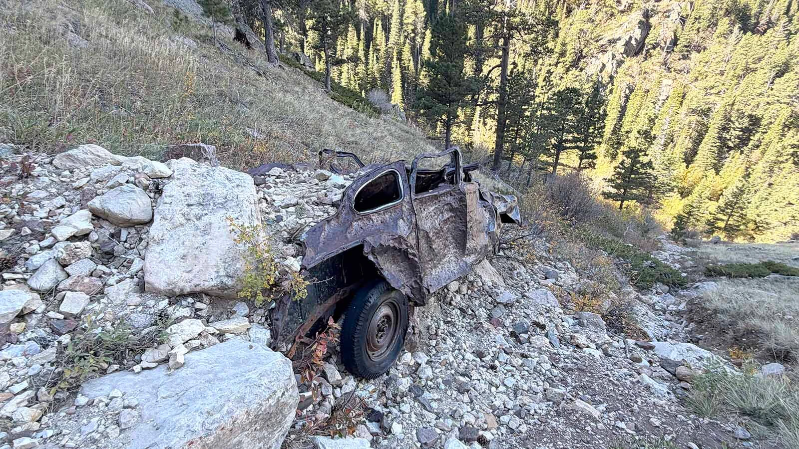 The battered remains of an old car sit below the Bridle Trail on Casper Mountain, where the wreck has been a familiar landmark to generations of hikers and horseback riders. Exactly when and how it got there remains a mystery.