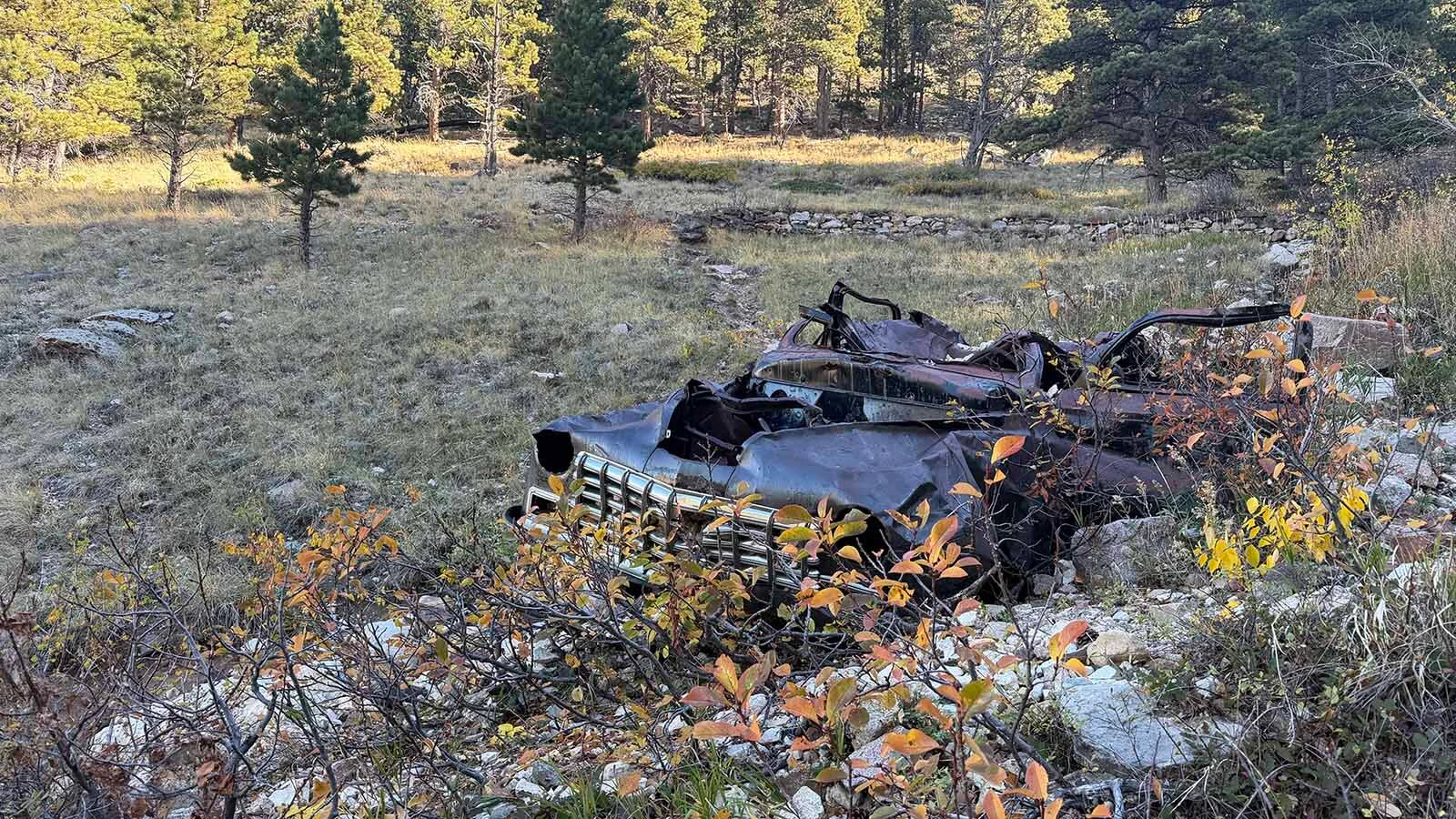 The battered remains of an old car sit below the Bridle Trail on Casper Mountain, where the wreck has been a familiar landmark to generations of hikers and horseback riders. Exactly when and how it got there remains a mystery.