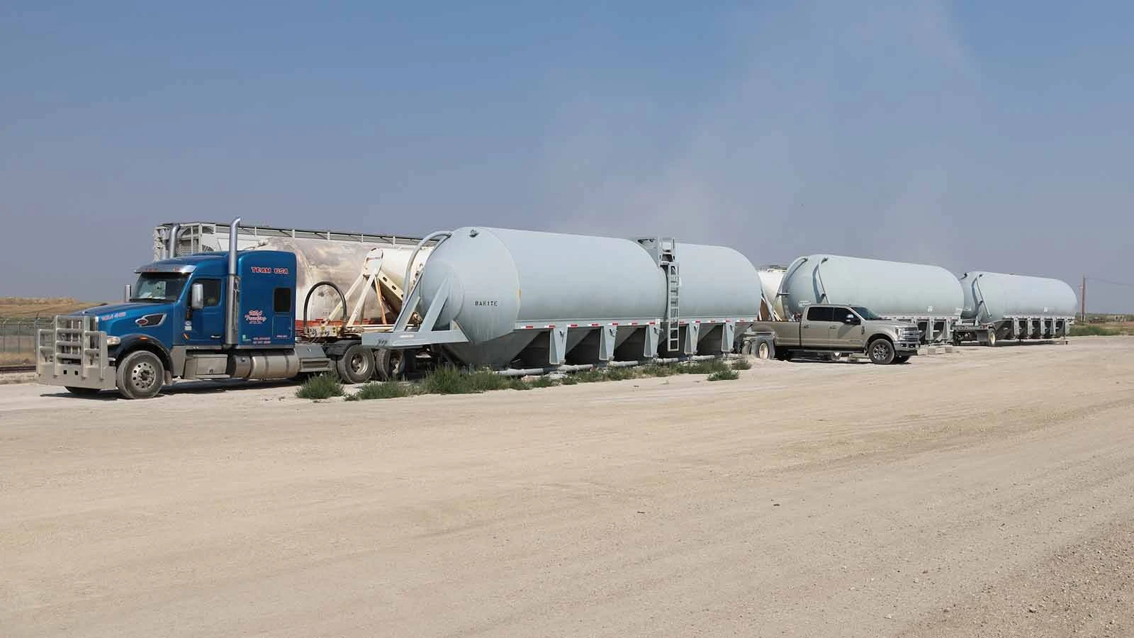 A semi takes on some barite stored at the rail yard.