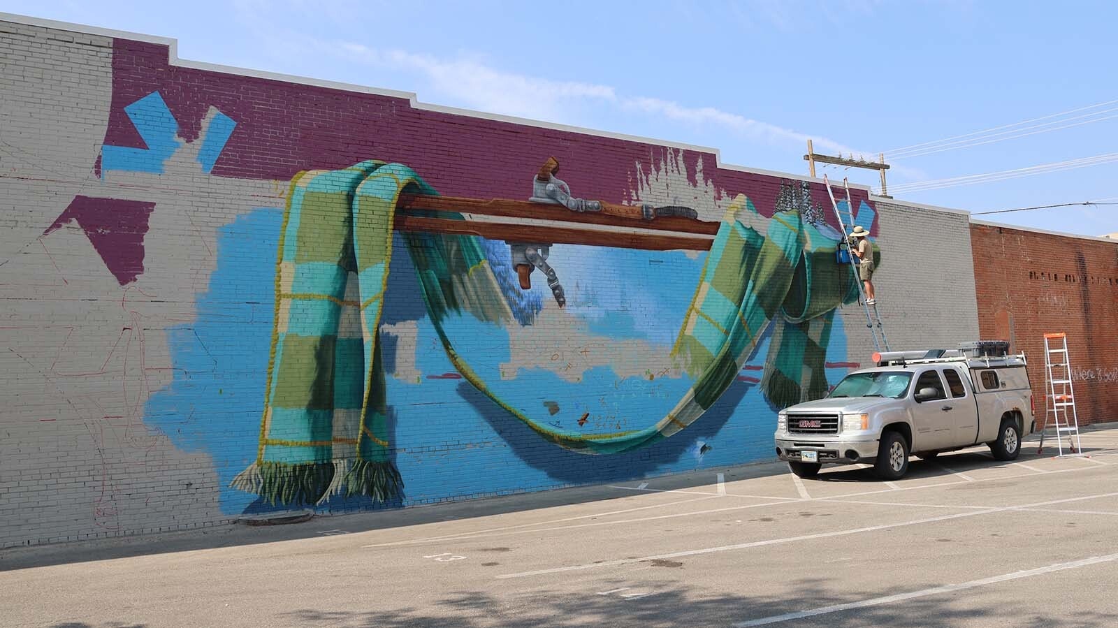 Artist Dan Toro makes progress on the mural of Casper Mountain a few days into his project.