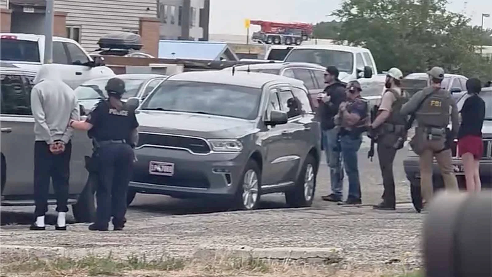Federal agents serving a search warrant drew neighbors to their windows Friday morning as law enforcement vehicles filled the area and a man was taken into custody.