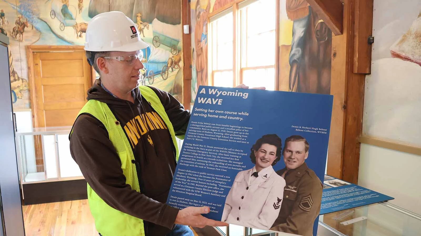  Museum Director John Woodward holds up a new exhibit panel that will be installed. There are nearly two dozen others celebrating and chronicling Wyoming veterans that will be installed.