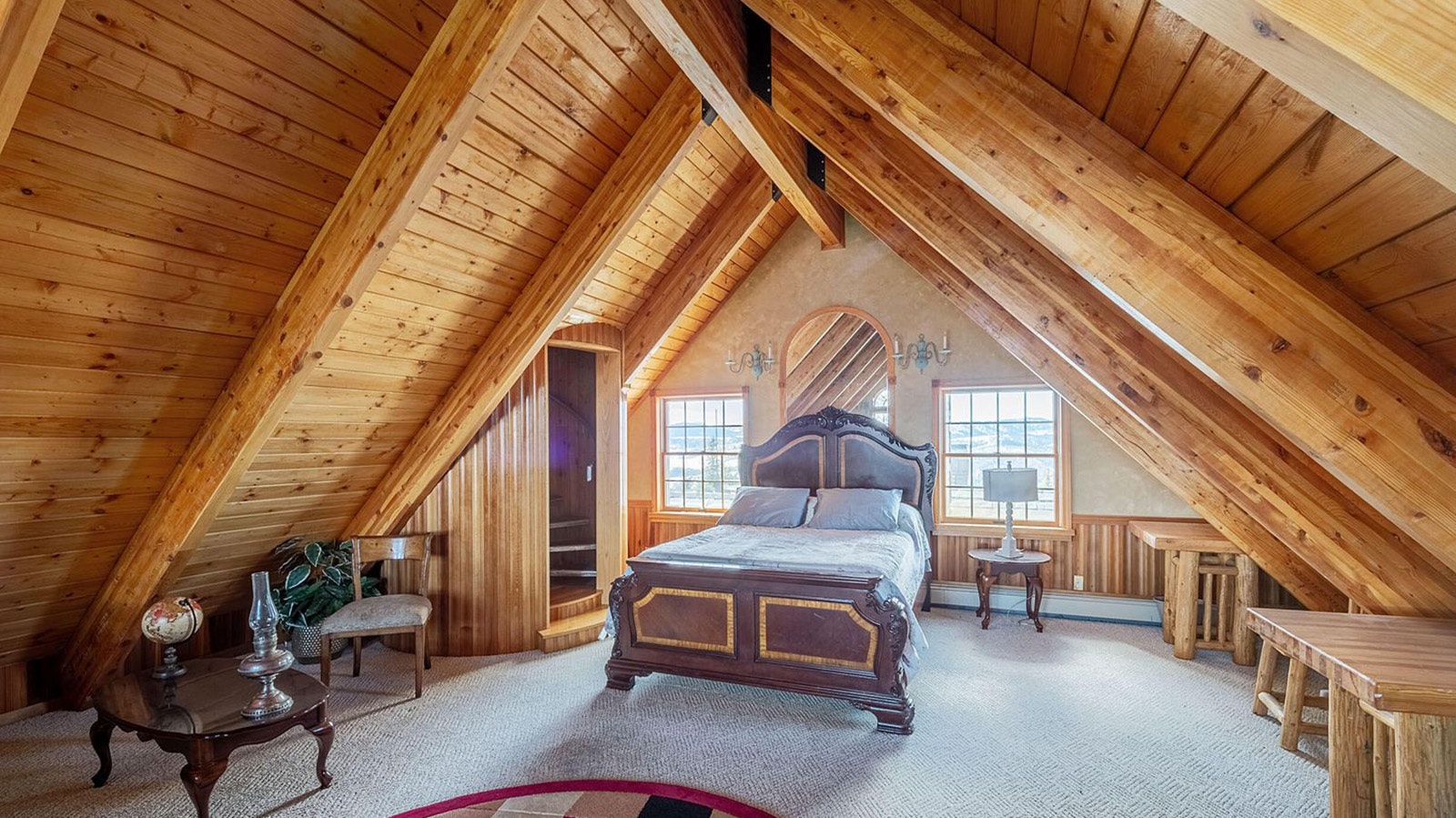 The exposes, rustic roofline makes for a cozy, Western bedroom.
