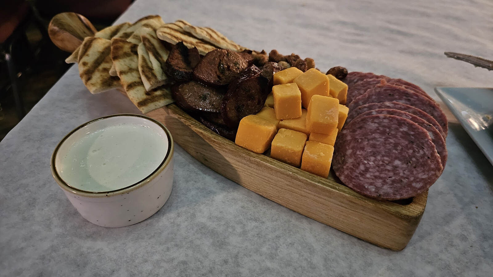 The charcuterie tray comes with sugared nuts, cheeses and meats, as well as blue cheese dip and grilled pita bread.