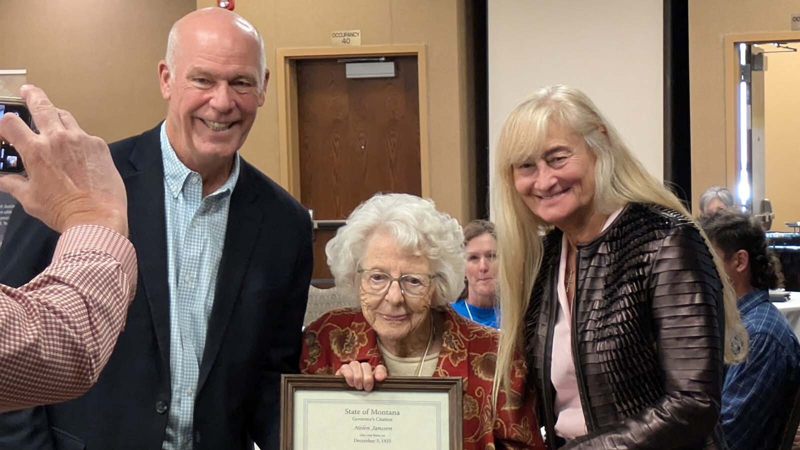 Montana Gov. Greg Gianforte, left, and first lady Susan Gianforte, right award a plaque to Helen Janssen of Forsyth.